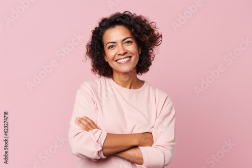 Group portrait photography of a satisfied Brazilian woman in her 40s wearing a chic cardigan against a pastel or soft colors background 