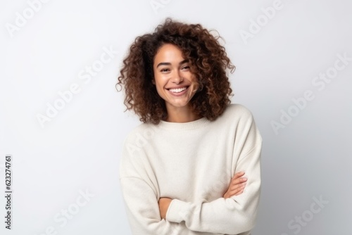 Medium shot portrait photography of a pleased Brazilian woman in her 30s wearing a cozy sweater against a white background  photo