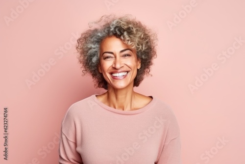 Portrait of a smiling african american woman looking at camera isolated over pink background