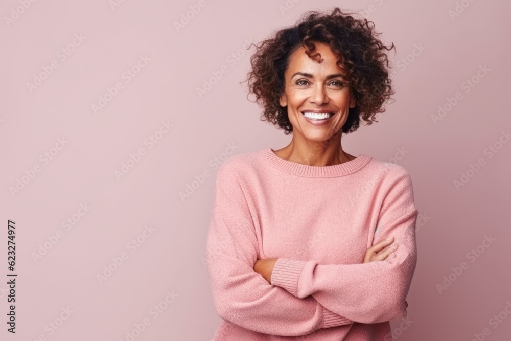 Portrait of a smiling african american woman with crossed arms isolated on a pink background Portrait of a smiling african american woman with crossed arms isolated on a pink background