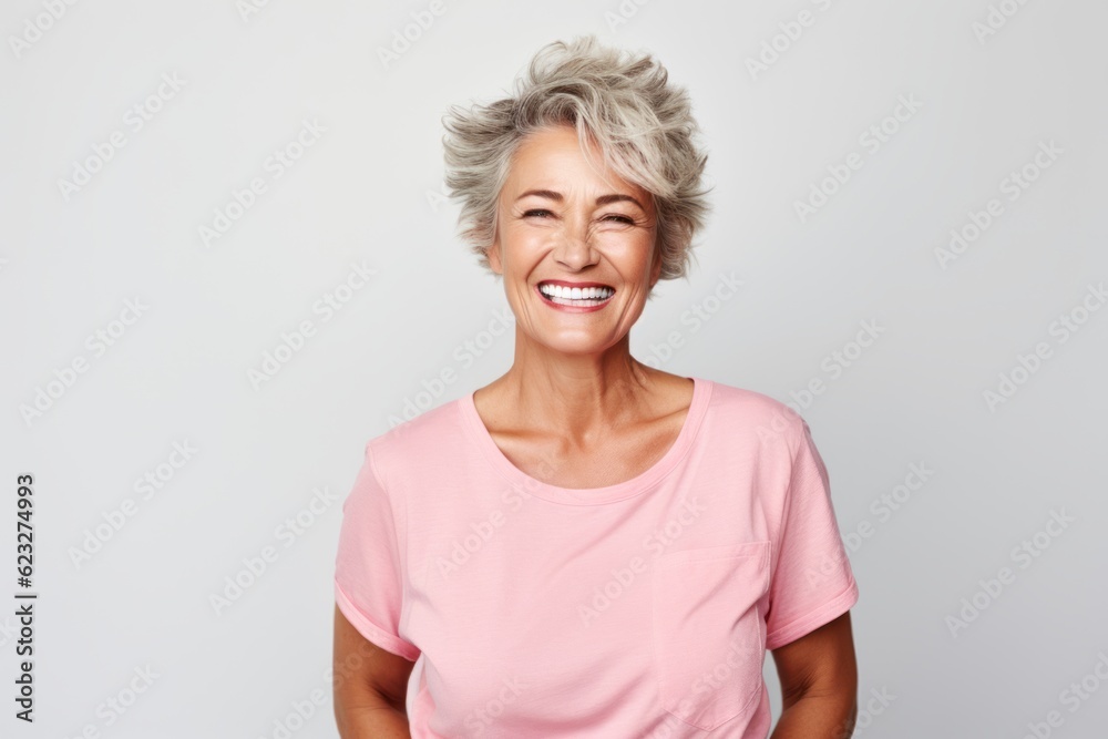Portrait of a smiling senior woman standing isolated on a white background Portrait of a smiling senior woman standing isolated on a white background