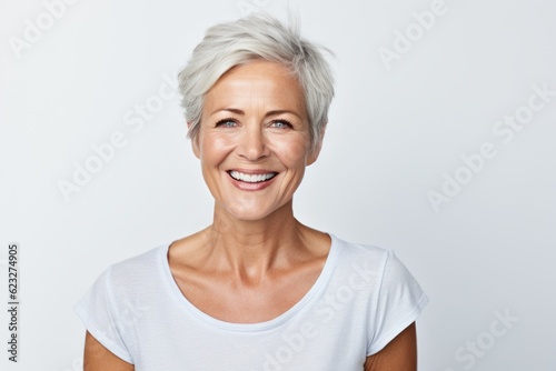 Portrait of a happy mature woman looking at camera over white background photo