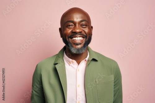 Smiling african american man looking at camera isolated on pink