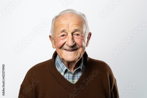 Portrait of a senior man smiling at the camera on a white background © Robert MEYNER