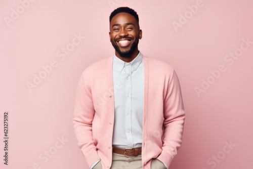 Cheerful african american man in pink jacket smiling at camera © Leon Waltz