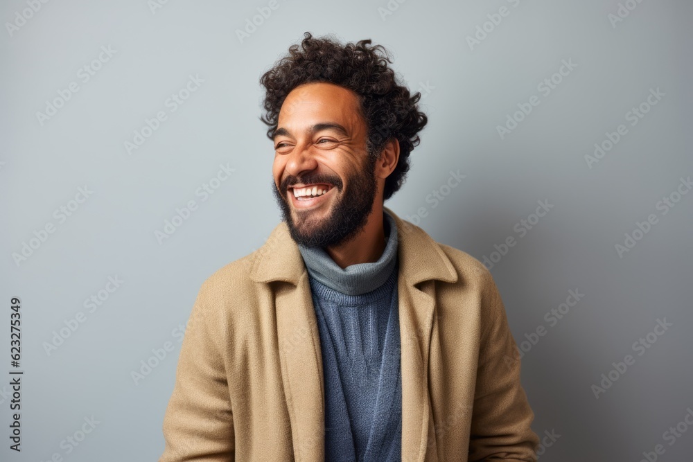 happy african american man in beige coat laughing on grey background happy african american man in beige coat laughing on grey background