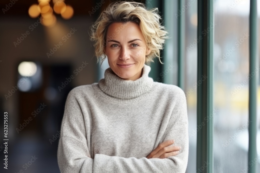Portrait of a smiling woman standing with arms crossed in a cafe Portrait of a smiling woman standing with arms crossed in a cafe