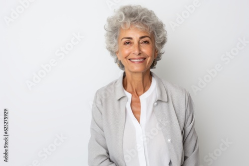 Portrait of beautiful senior woman smiling at the camera on white background