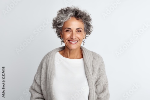 Portrait of a smiling senior woman looking at camera isolated on a white background