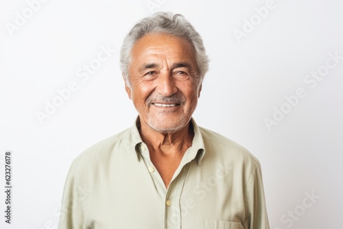 Lifestyle portrait photography of a pleased Brazilian man in his 70s wearing a chic cardigan against a white background  photo