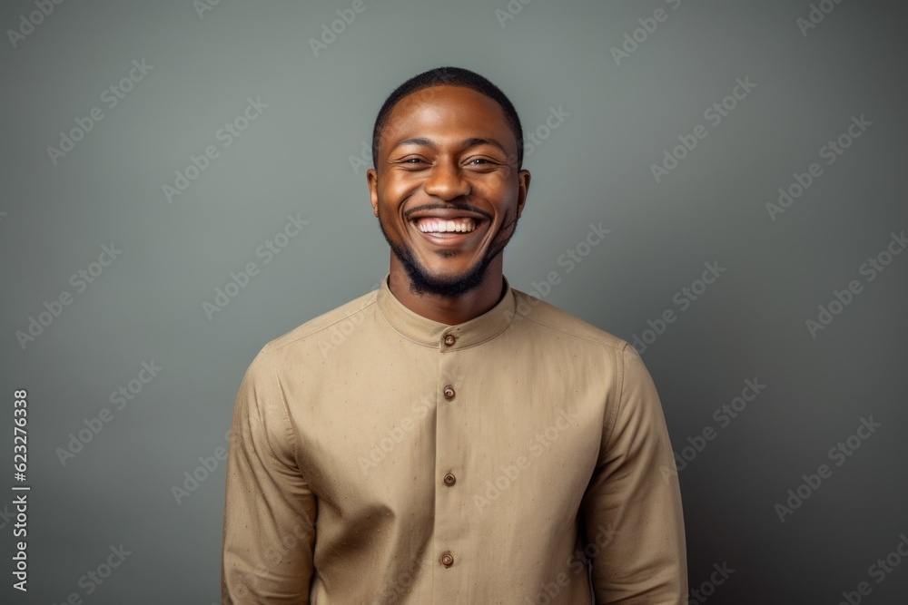happy african american man smiling at camera isolated on grey background