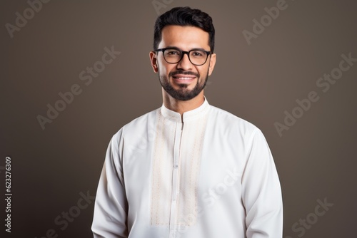 Portrait of a handsome Indian man wearing eyeglasses and looking at camera