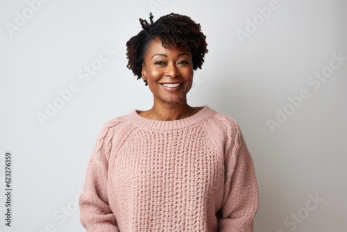Portrait of a smiling african american woman standing against white background