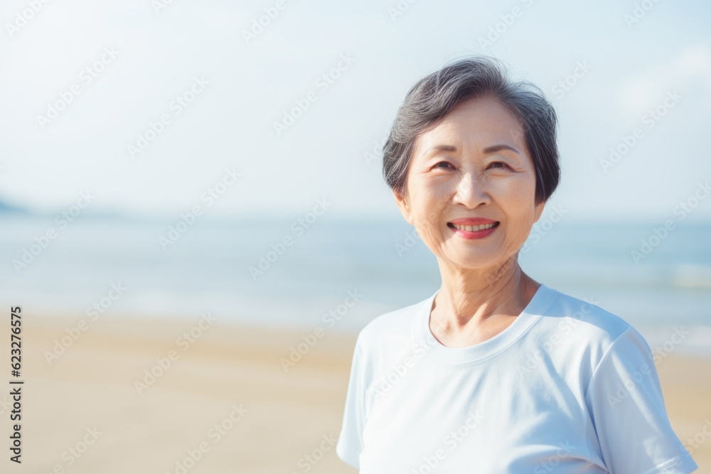 Portrait of senior asian woman in sportswear on the beach Portrait of senior asian woman in sportswear on the beach