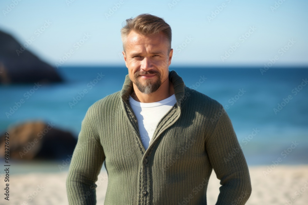 Medium shot portrait photography of a pleased Russian man in his 40s wearing a chic cardigan against a beach background Medium shot portrait photography of a pleased Russian man in his 40s wearing a chic cardigan against a beach background