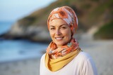 Portrait of beautiful middle aged woman wearing headscarf on the beach