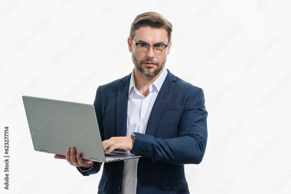 Millennial man in suit working on laptop in studio. Hispanic man checking information on laptop, typing information on laptop. Middle aged man searching information on laptops. Millennial man in suit working on laptop in studio. Hispanic man checking information on laptop, typing information on laptop. Middle aged man searching information on laptops.