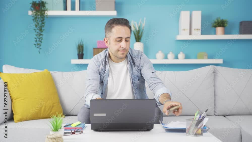 Man using laptop nervously talking on the phone. Man using laptop nervously talking on the phone.
