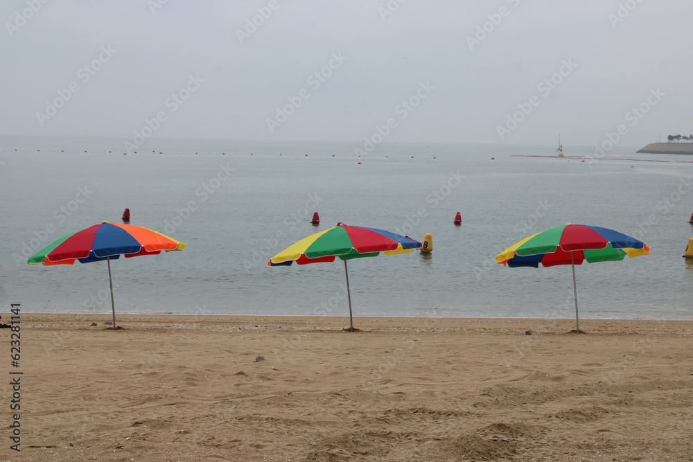 Colorful umbrellas on overcast beach Colorful umbrellas on overcast beach