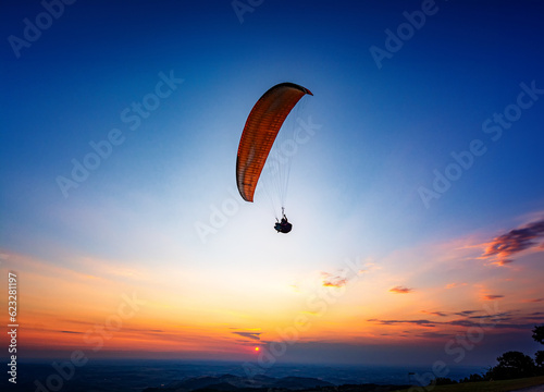 paraglider silhouette at sunset