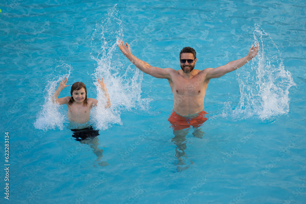 Father and son in swimming pool on summer vacation. Child with dad playing in pool. Dad and kid in pool at summer day. Leisure and swimming at holidays. Father have fun with the son in the pool.