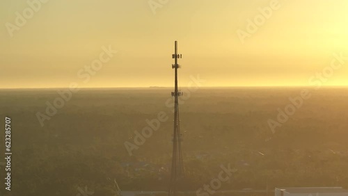 Aerial view of telecommunications cell phone tower with wireless communication 5g antennas for network signal transmission