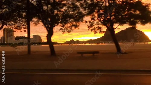Um amanhecer no outono, Rio de janeiro, com passagem de carro com vista do pao de açucar photo