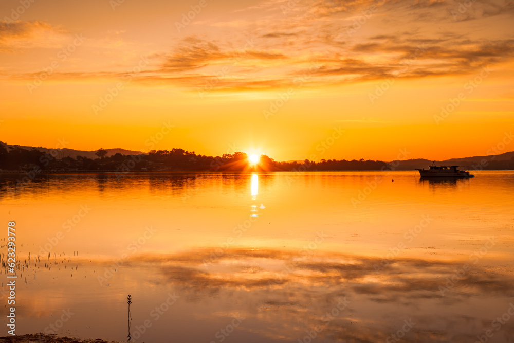 Orange hues - sunrise over the water