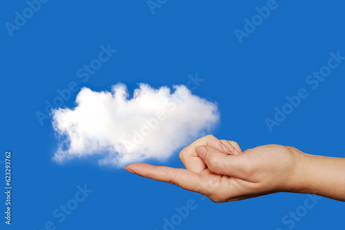 finger holding a white cloud 