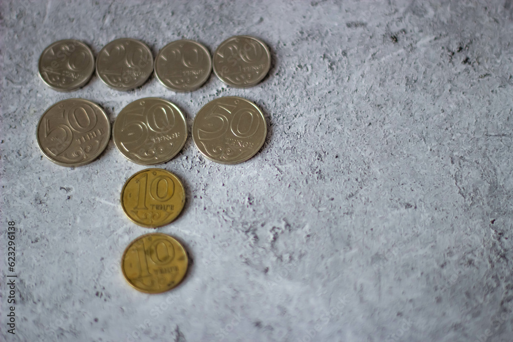 Kazakh money. Tenge coins. Coins on a gray background Kazakh money. Tenge coins. Coins on a gray background