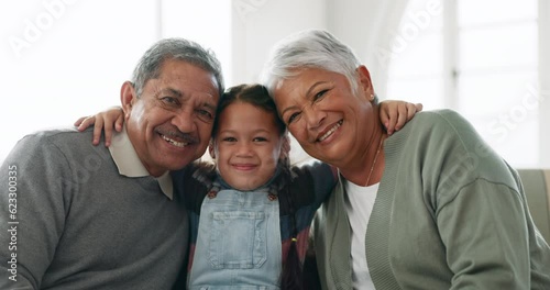Face of child, happy grandparents and hug on sofa in living room for love, care and quality time together. Portrait of girl kid embrace grandmother, grandfather and family with smile to relax at home