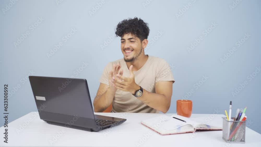Man looking at laptop applauding. Man looking at laptop applauding.