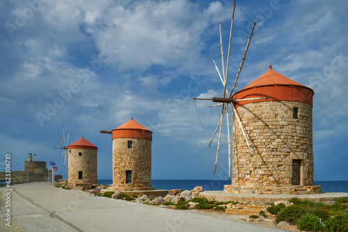Three medieval windmills standing on the breakwater of the port of Madraki. Greece The city of Rhodes, the island of Rhodes. Recognizable symbol of Rhodes