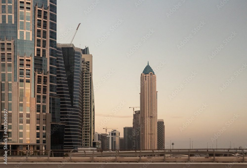 View at sunset from the window of a tourist bus on the architecture of the city of Dubai, United Arab Emirates