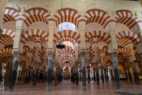 Interior of Mezquita Cathedral in Cordoba, Spain. Low angle view of the candy cane striped columns and marble floor of the cathedral.