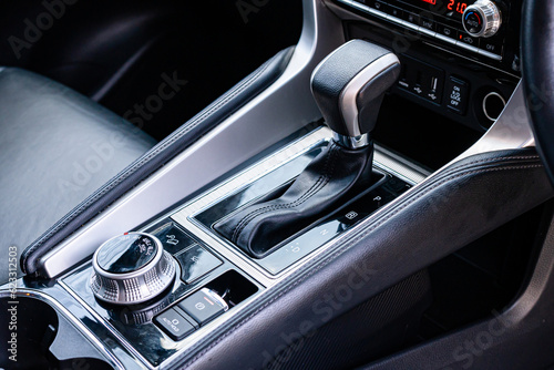 automatic transmission shift selector in the car interior. Closeup a manual shift of modern car gear shifter. 4x4 gear shift