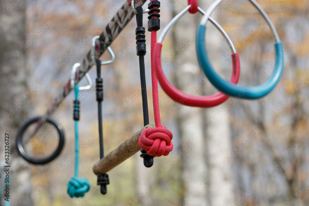 Recreational exercise hoops and bars hanging on a line outdoors
