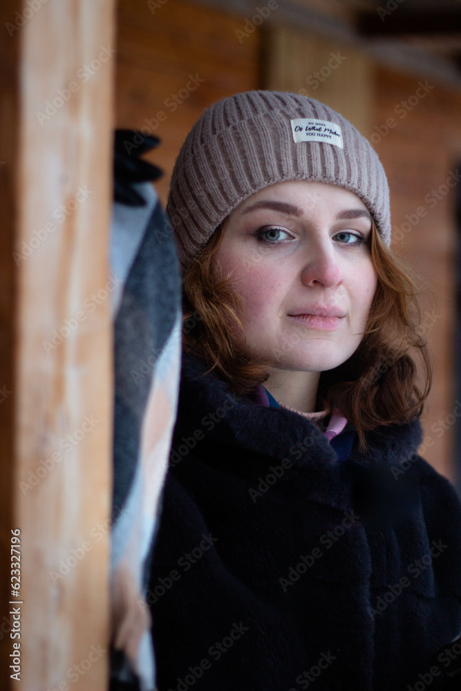 Young woman in winter on the street. She wrapped herself in a scarf. 
