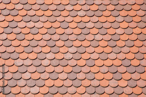 Red tile roof clay tiles roof of a private house made of shingles photo