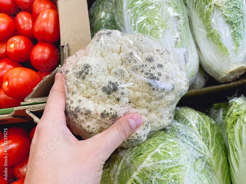 Quadro su tela Spoiled cauliflower with mold in a hypermarket. Selective focus