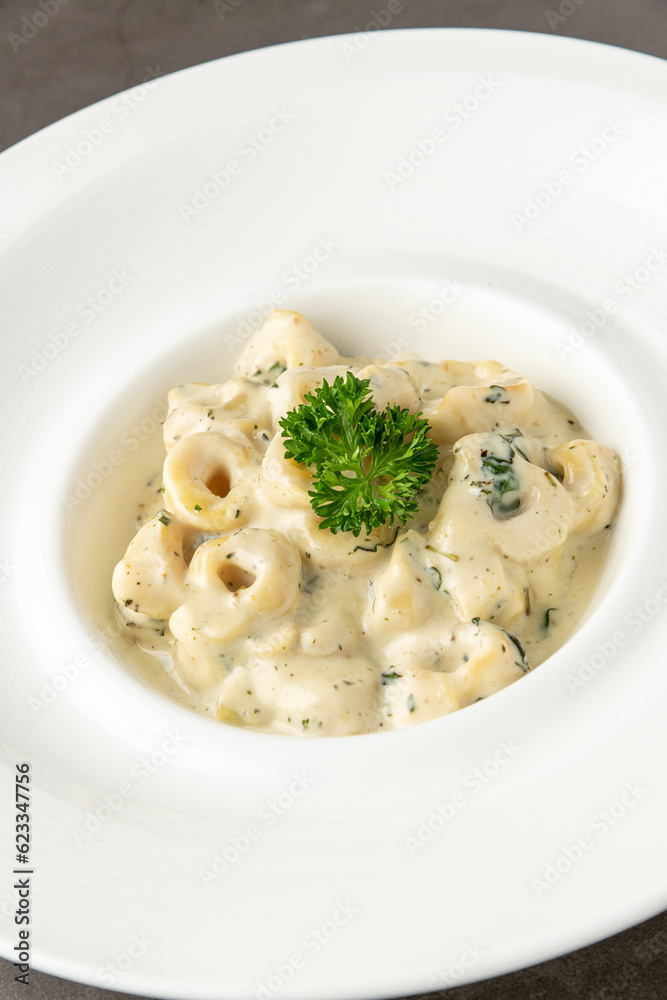 Delicious italian food tortellini pasta with mushroom cream sauce and cheese Delicious italian food tortellini pasta with mushroom cream sauce and cheese