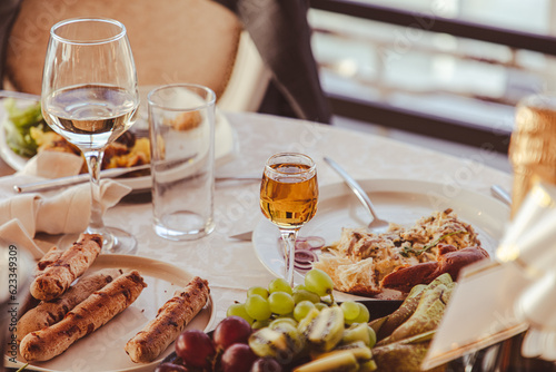 Close up of glasses of wine and snacks on the table