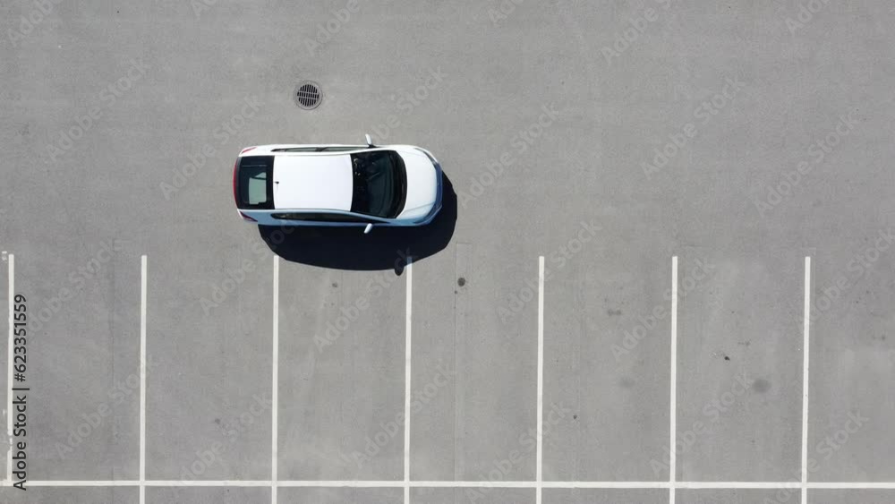 Top view car reversing in a parking space