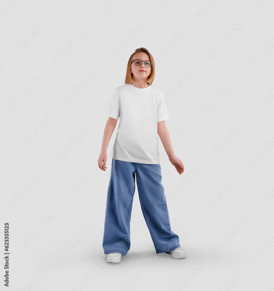 Mockup of a white t-shirt on a posing child, a girl in a shirt, jeans, sneakers, isolated on the background, front view.