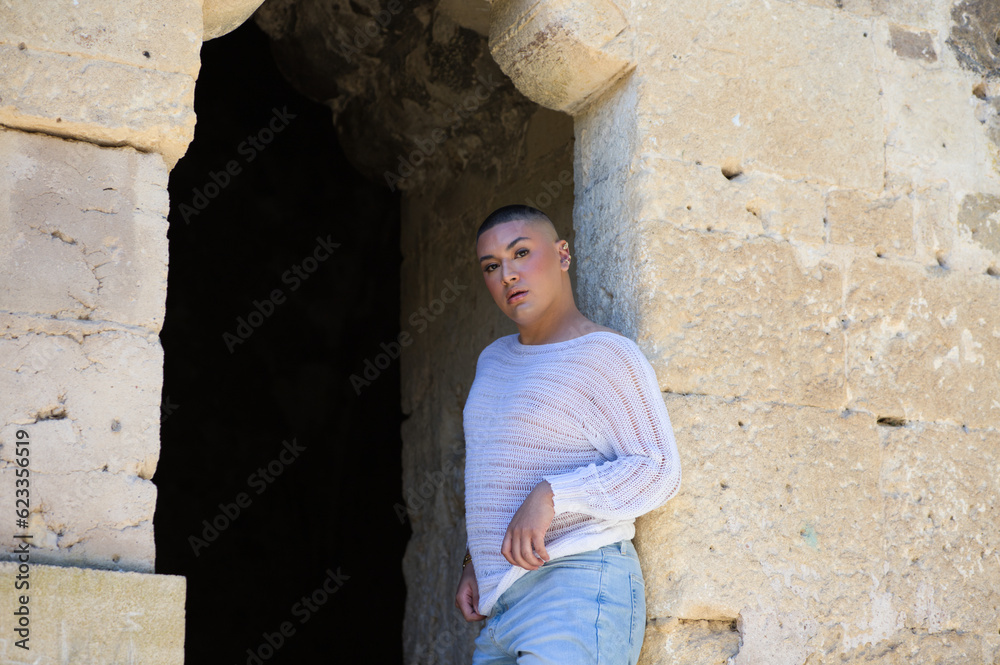 Non binary latin and young person, is in a castle making different body expressions in the hole of the door. Concept of diversity, homosexuality and gay pride. Non binary latin and young person, is in a castle making different body expressions in the hole of the door. Concept of diversity, homosexuality and gay pride.