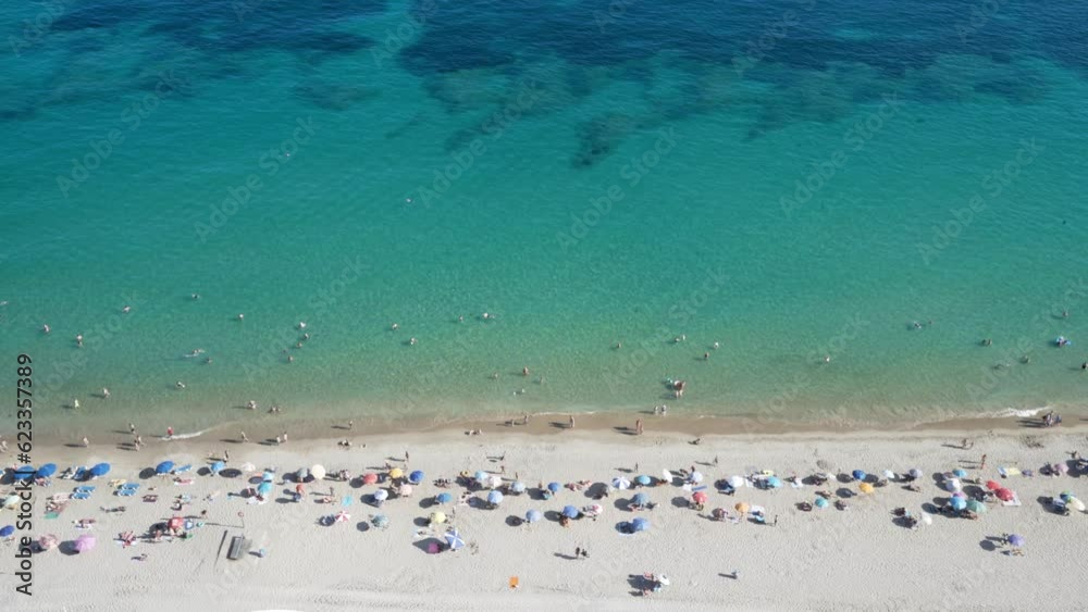 Bird’s eye view of busy summer Mediterranean beach with visible reef 4K Bird’s eye view of busy summer Mediterranean beach with visible reef 4K