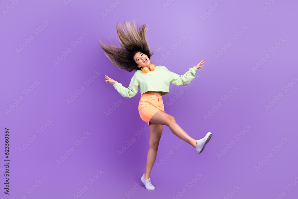 Full size photo of girlish good mood woman dressed green shirt stylish skirt fooling jumping have fun isolated on purple color background