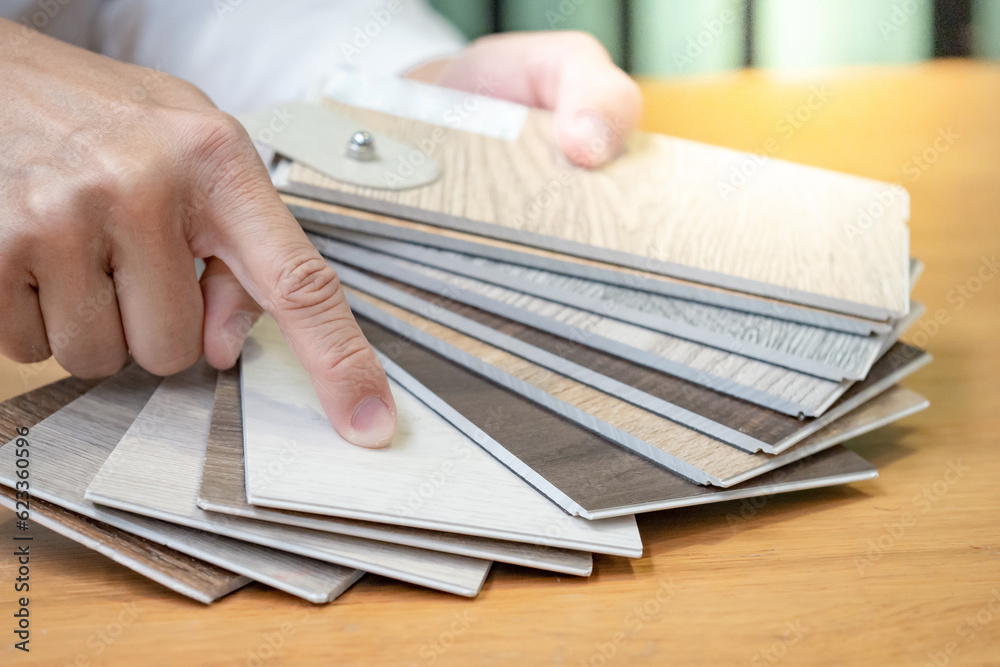 Sample Hand Designer hand choosing and pointing at wood texture laminate material ...