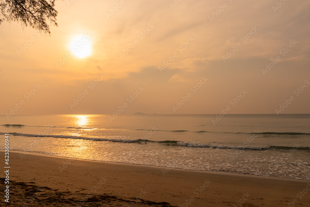 View of sunrise in the morning on the beach with golden sky.