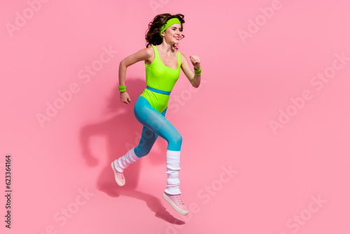 Photo of positive sporty trainer lady jump run fast prepare for sprint competition isolated on pastel color background